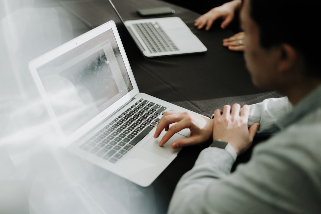 a-man-sitting-in-front-of-a-laptop-computer-oedkpaxymxu